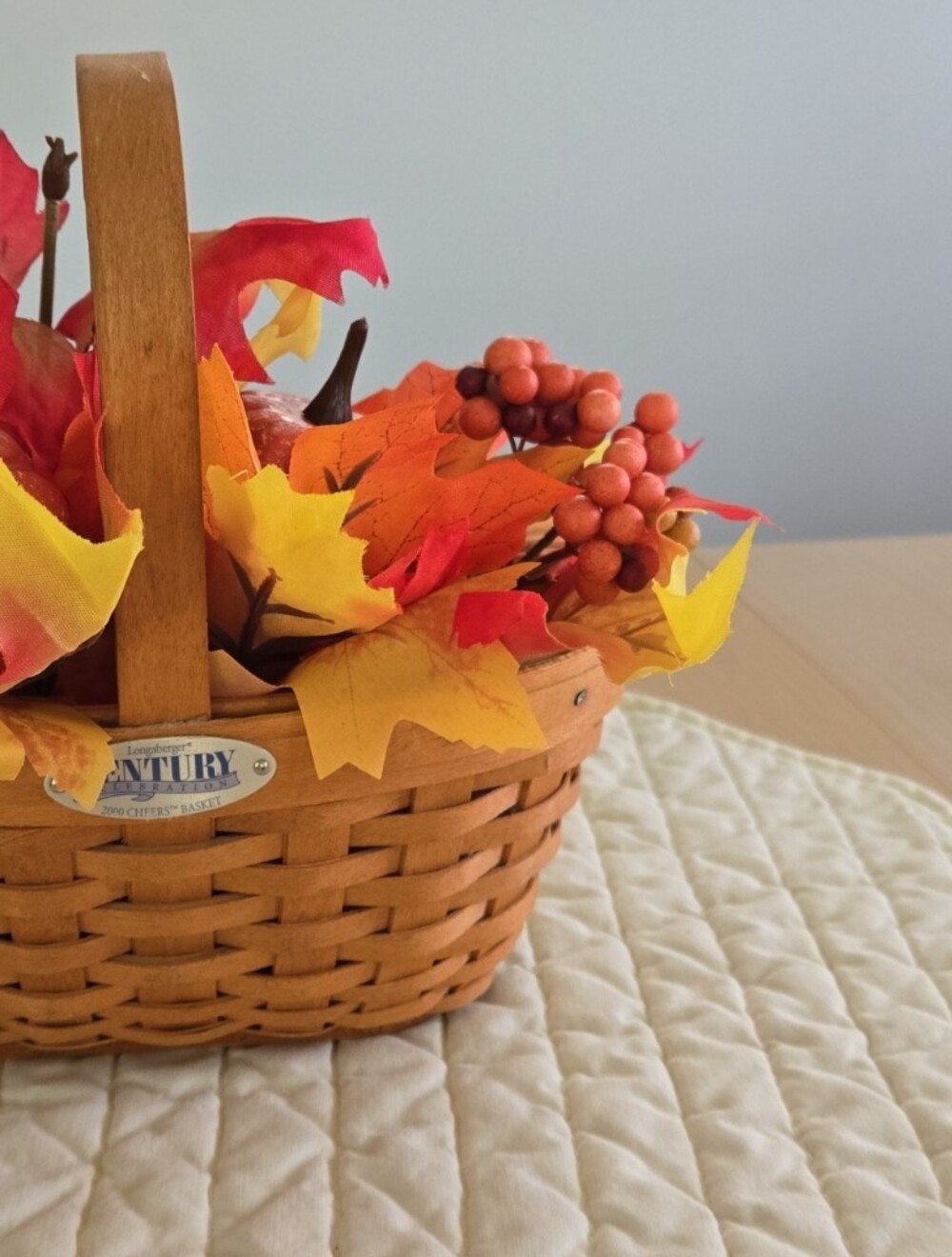 Longaberger woven basket with orange and yellow fall foliage